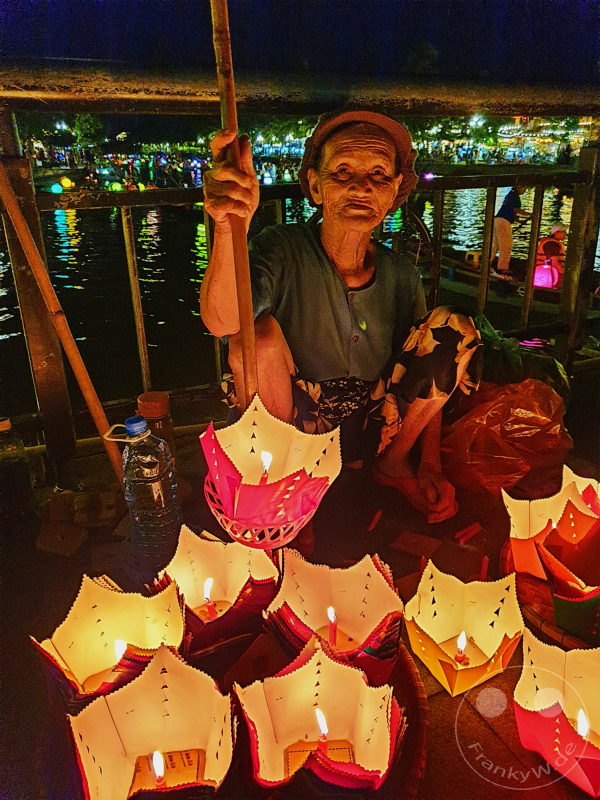 Vietnam - Hoi An by night - Floating lanterns with candle from an old woman