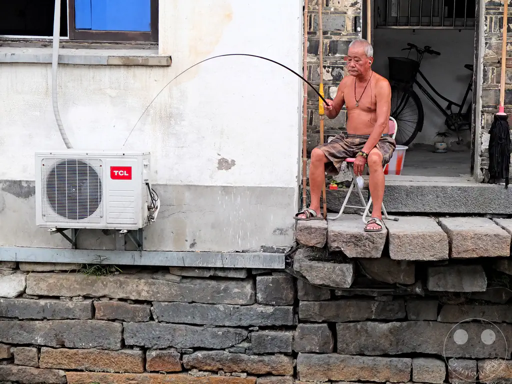 China - Suzhou - A man fishing by the canal