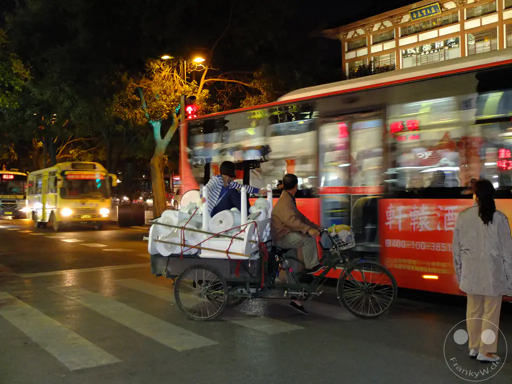 China - Xi'an - a busy nighttime street scene - three-wheeled cargo tricycle