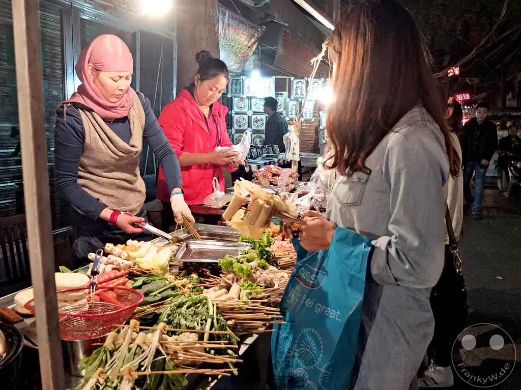 China - Xi'an - lively nighttime street food scene inside the famous Muslim Quarter (Huimin Jie) - street food